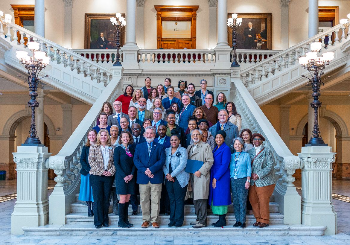 Governor's Circle Awardees pose together on the steps in the State Capitol rotunda