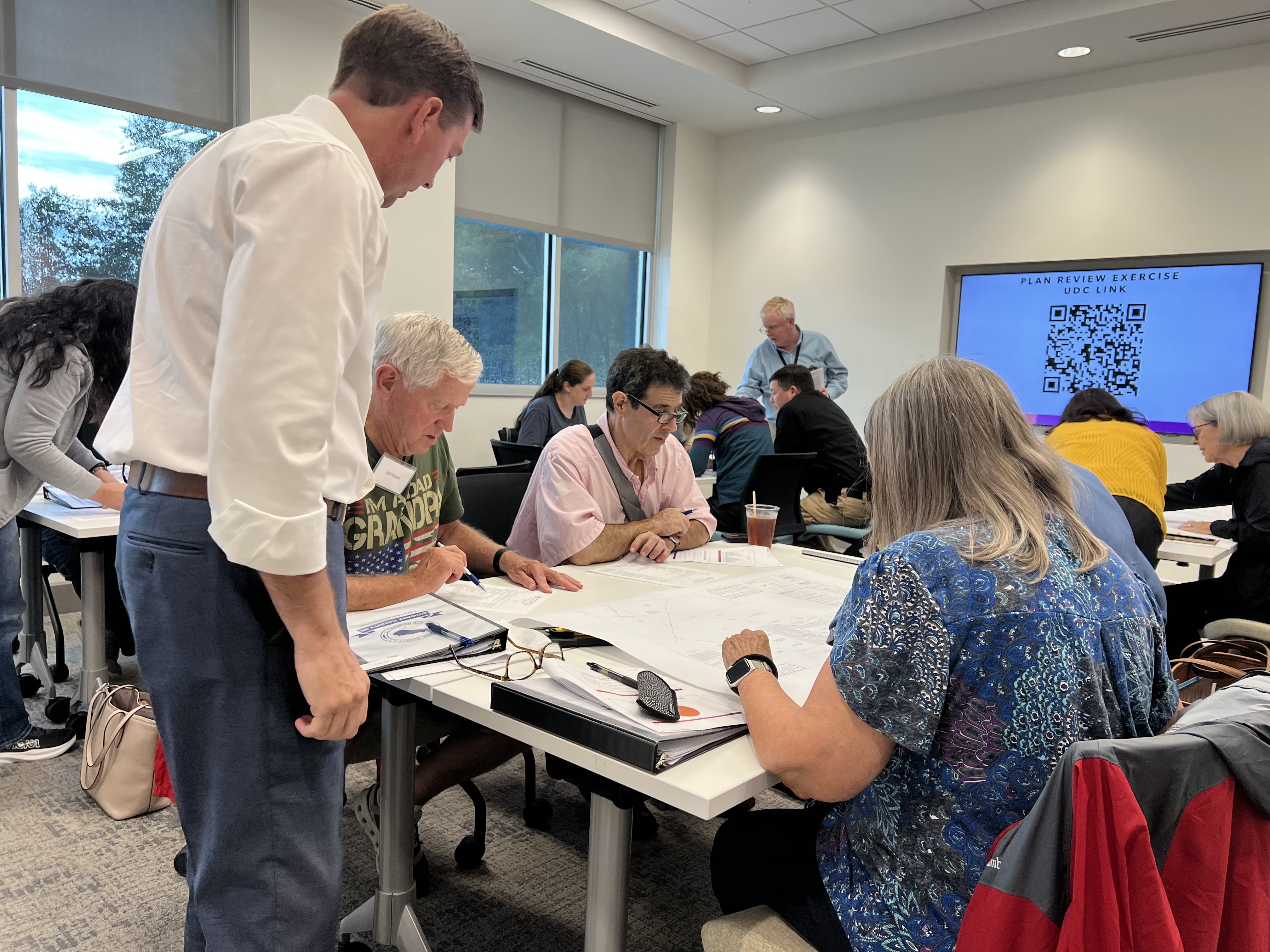 Planning Director works with groups of Oconee County 101 participants seated at tables